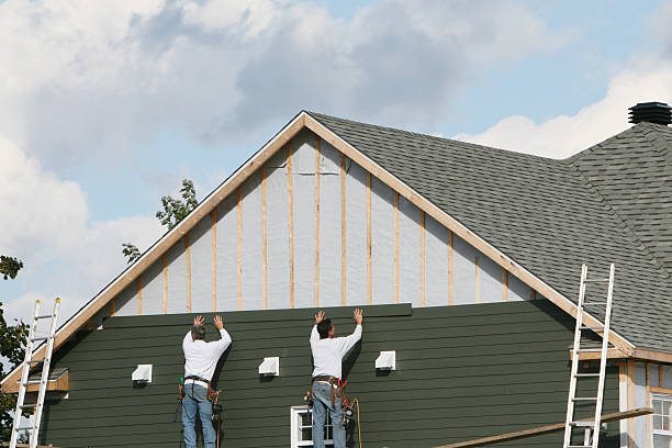 Professional Siding technician working in Walpole, MA